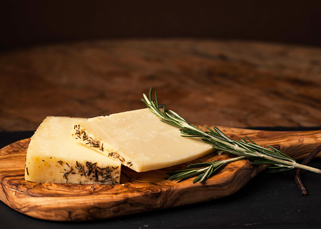 This is a picture of Sartori Rosemary Asiago cheese, offered by Fromagination.