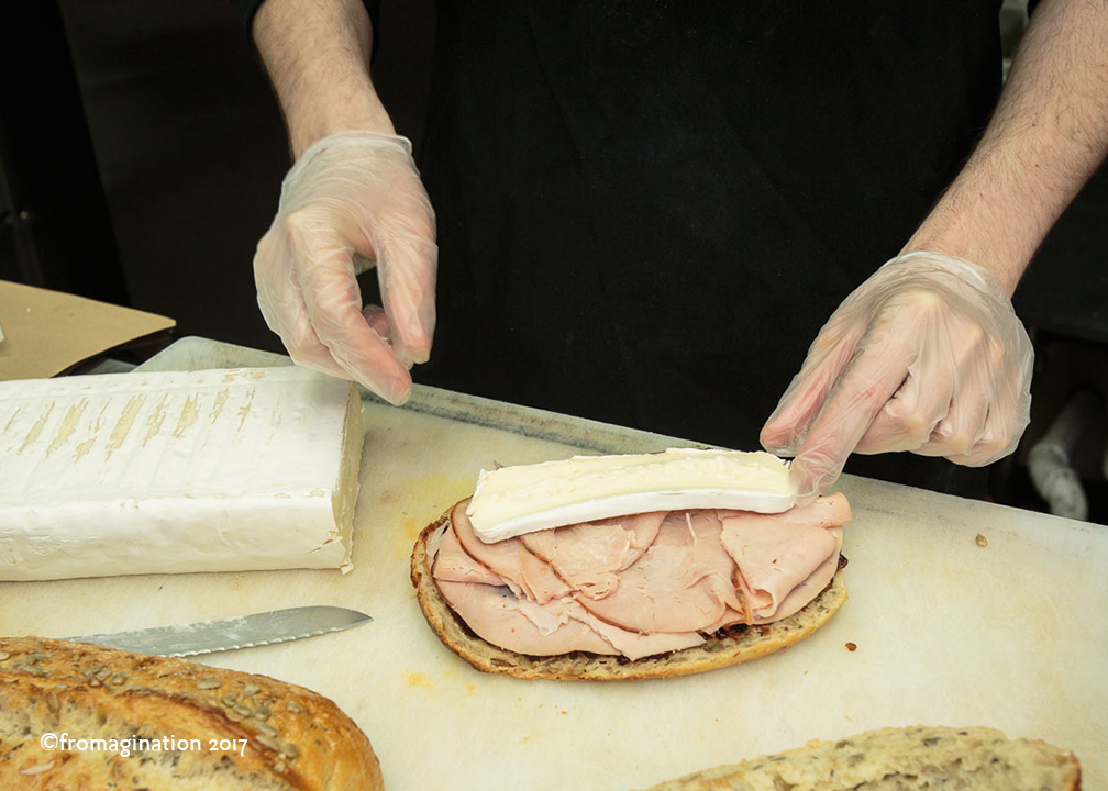Putting Brie on a Fromagination Signature Sandwich
