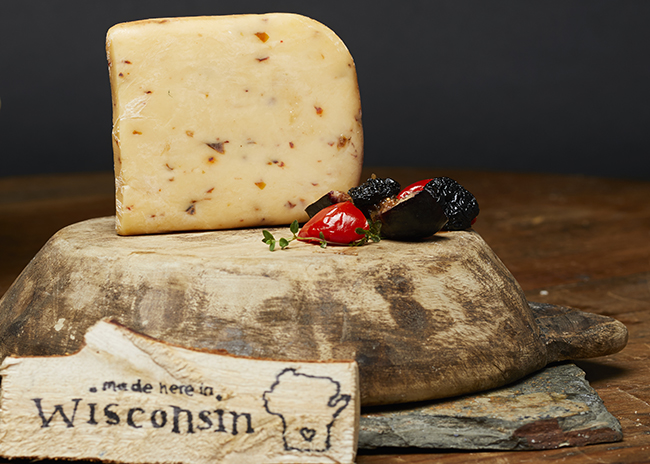 This is a picture of Three Chili Pepper Gouda cheese, featured at Fromagination.
