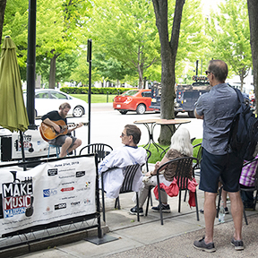 This is a picture of Make Music Madison outside the Fromagination shop.