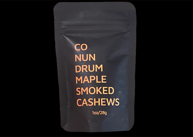 This is a picture of Conundrum Maple-Smoked Cashews, offered by Fromagination.