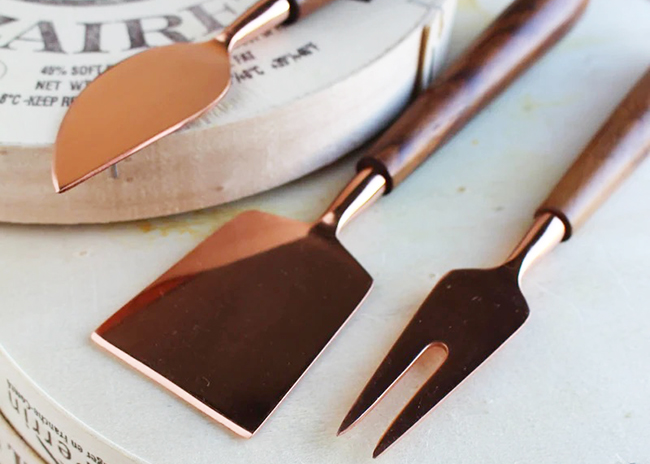 This is a picture of a Copper and Wood Cheese Knife Set, offered by Fromagination.