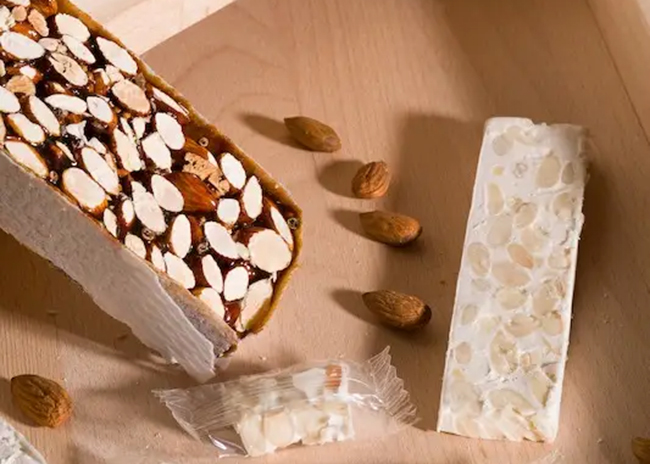 This is a picture of a White Nougat Almond Bar, offered by Fromagination.