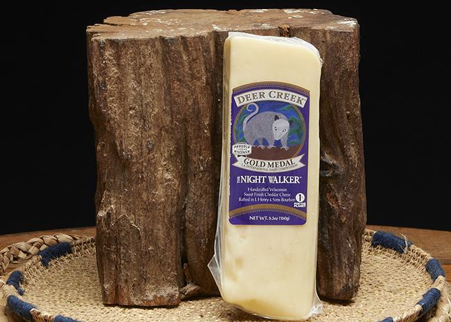 This is a picture of Deer Creek's Night Walker Cheddar cheese, offered by Fromagination.