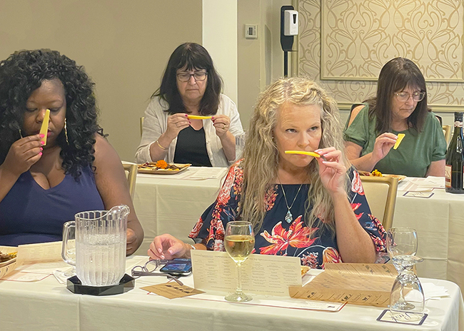 About Us.Cheese Class.650x464.72res This is a picture of a Fromagination cheese class with participants sampling cheeses.