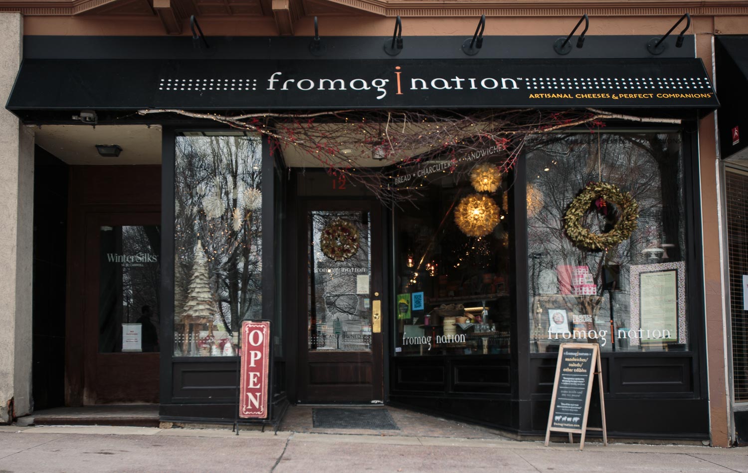 visit-us-storefront-winter-wreaths The Fromagination storefront on Carroll Street, with wreaths in the windows.